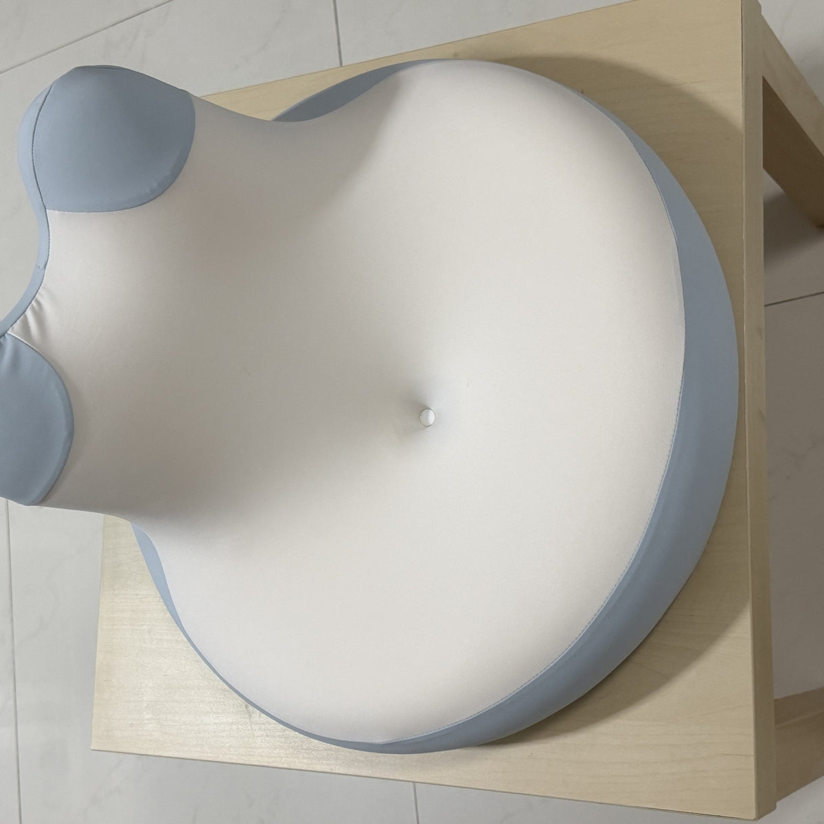 Top view of the blue and white CozyEnjoy Scroll Pillow showing its broad cushioned surface and raised back